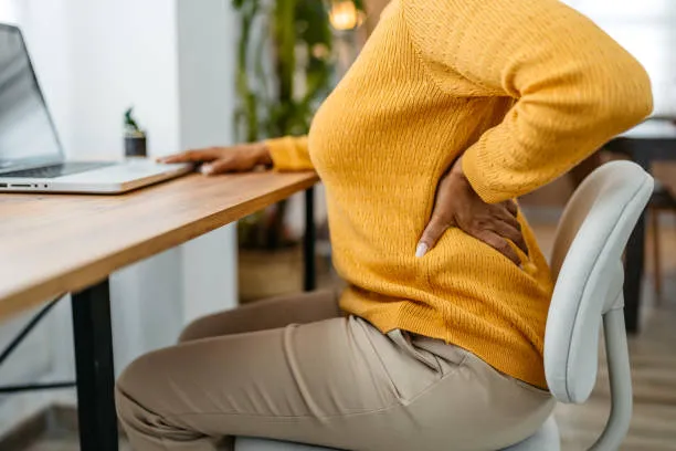 tired-young-woman-having-back-pa